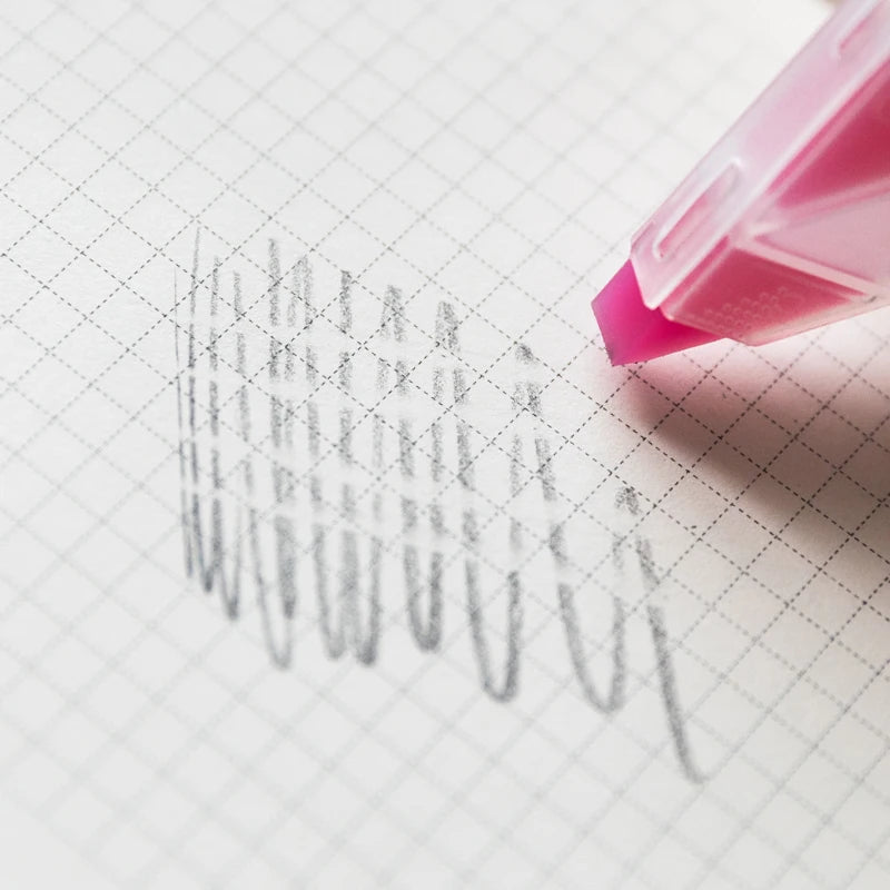 Pink highlighter pen on a piece of graph paper