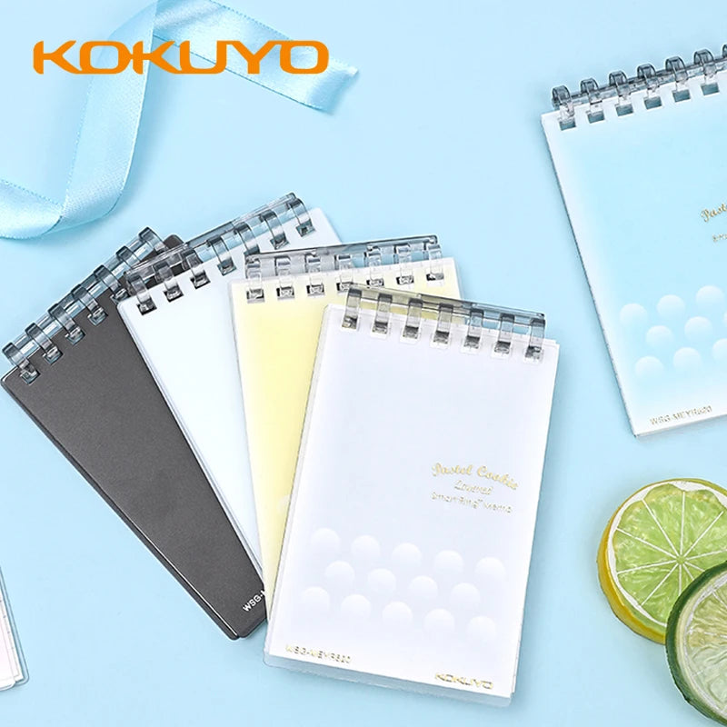 Kokuyo notebooks on a light blue background with lemon slices.