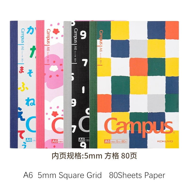 Set of four notebooks with different colorful designs on a white background