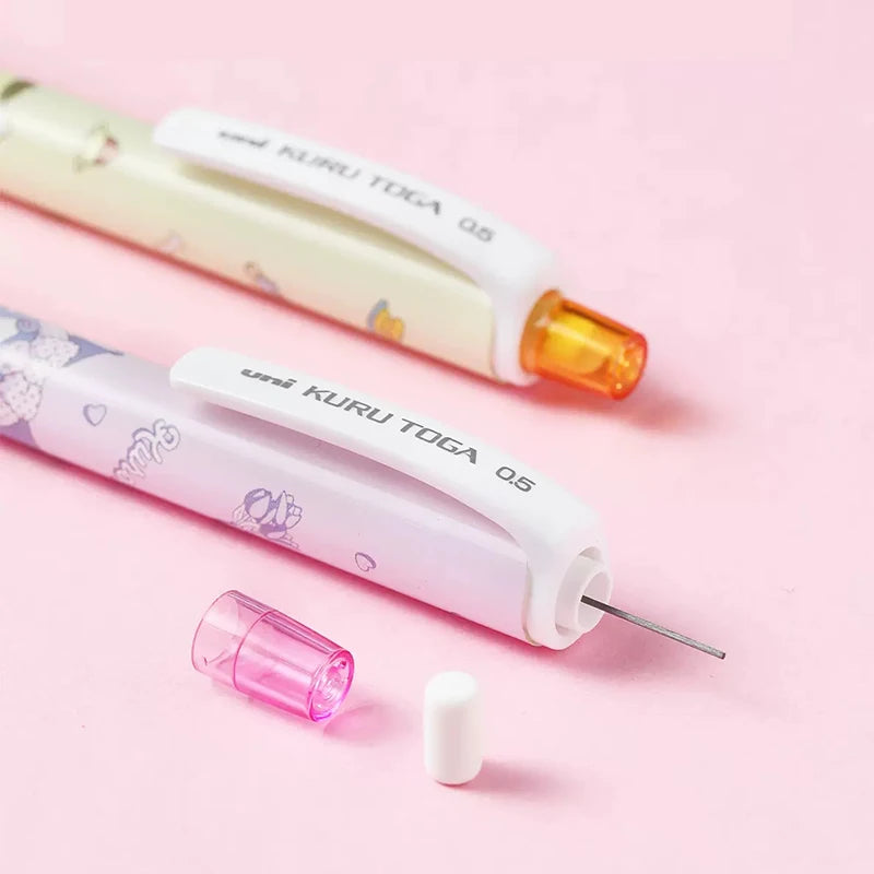 Two UNI kuru toga mechanical pencil with colorful accents on a pink background