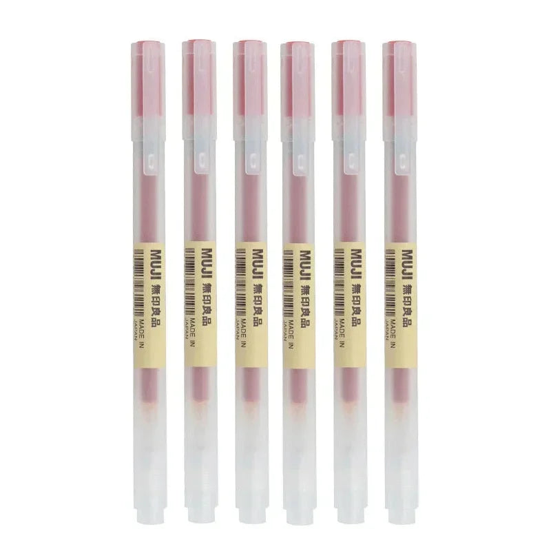 Set of five MUJI lip pencils with pink tips on a white background