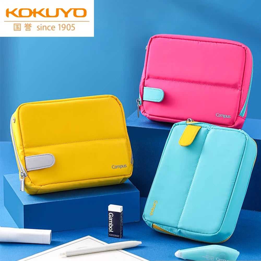 Three colorful pencil cases on a blue background with Kokuyo branding.
