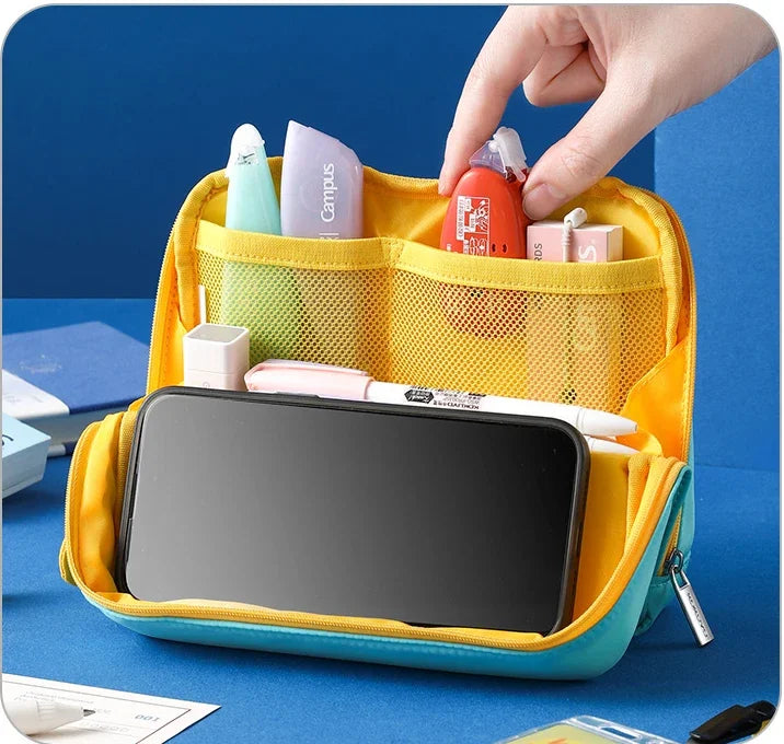 Bentopop yellow and blue stationery organizer with various items on a blue background