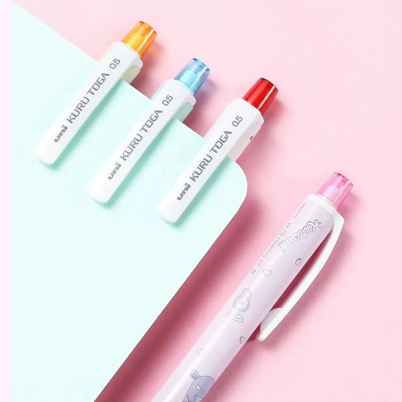 Set of colorful UNI kuru toga mechanical pencil with visible branding on a pink and light blue gradient background