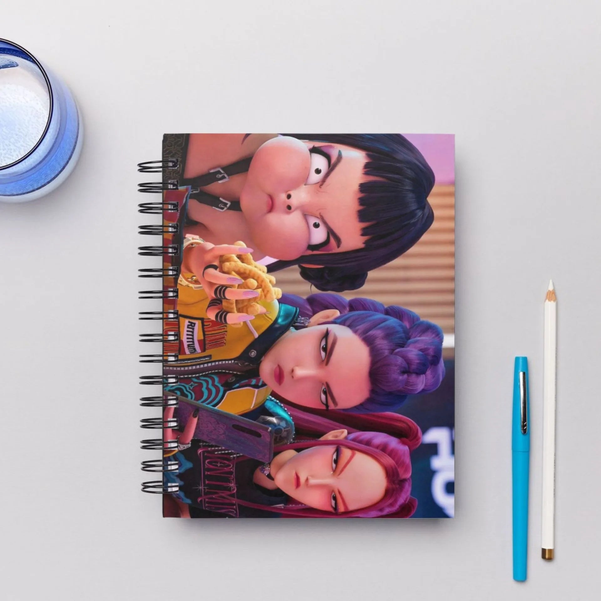 Bentopop notebook with Kpop Demon Hunters characters on a white surface with a pen and small container.