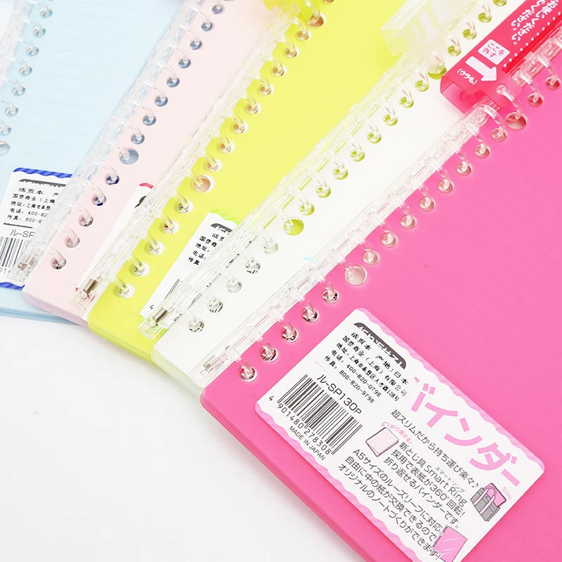 Colorful notebooks with labels on a light blue background